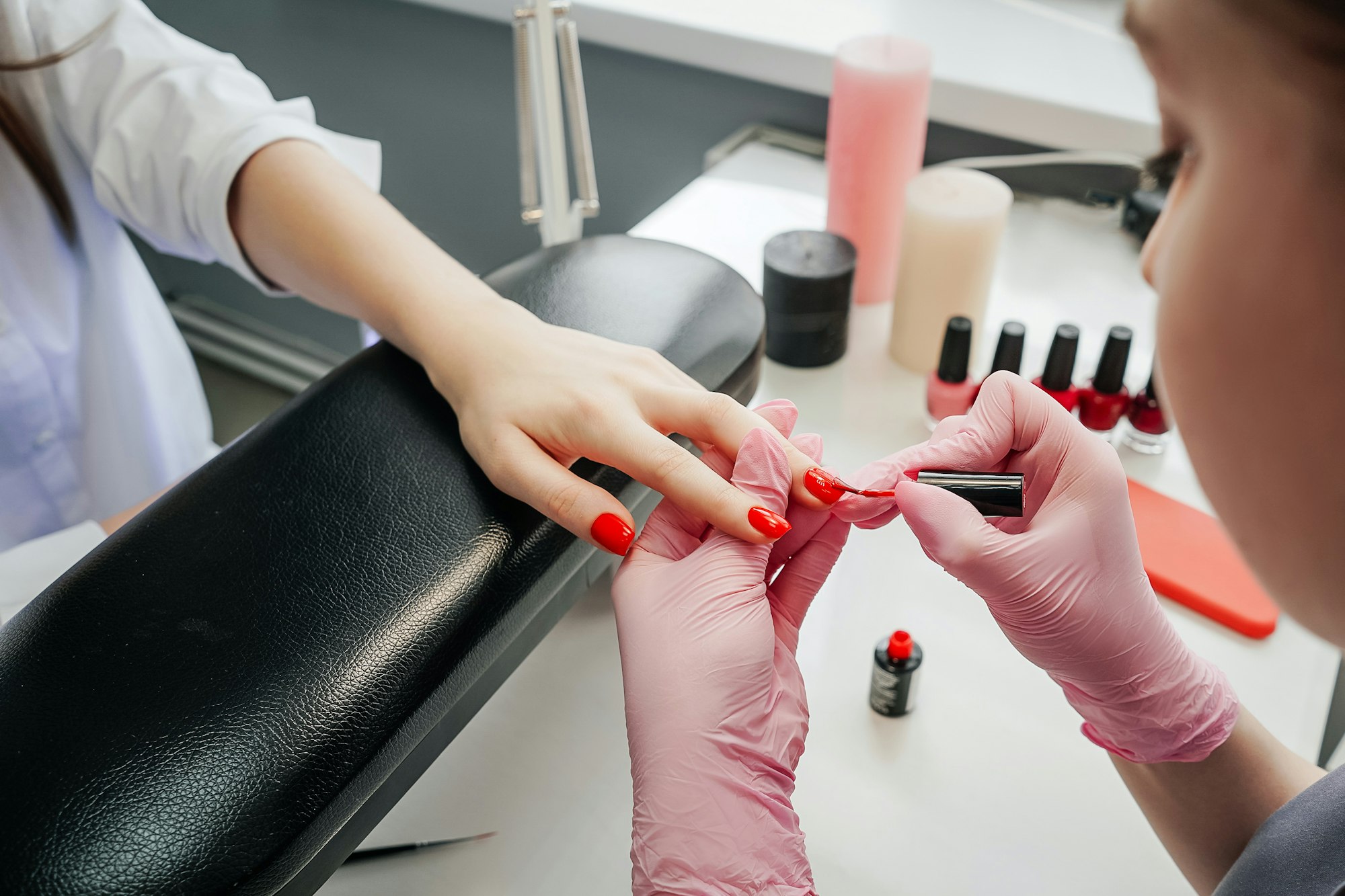 Young woman getting manicure in beauty salon